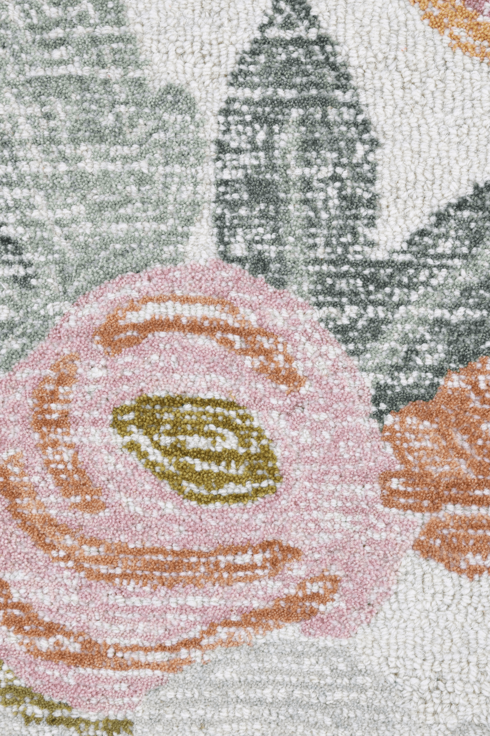 Close-up of the Bloomfield Rug, featuring pastel blooms and leafy patterns on a soft ivory background.