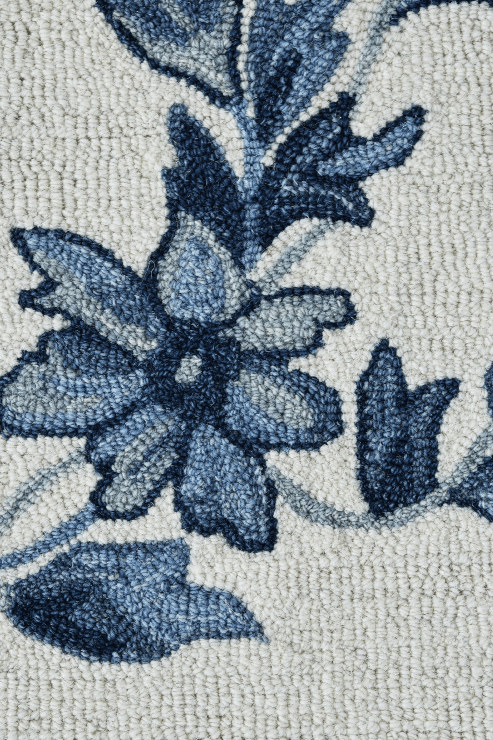 Close-up of the Azure Bloom Rug featuring delicate blue flowers and vines on a soft ivory background.
